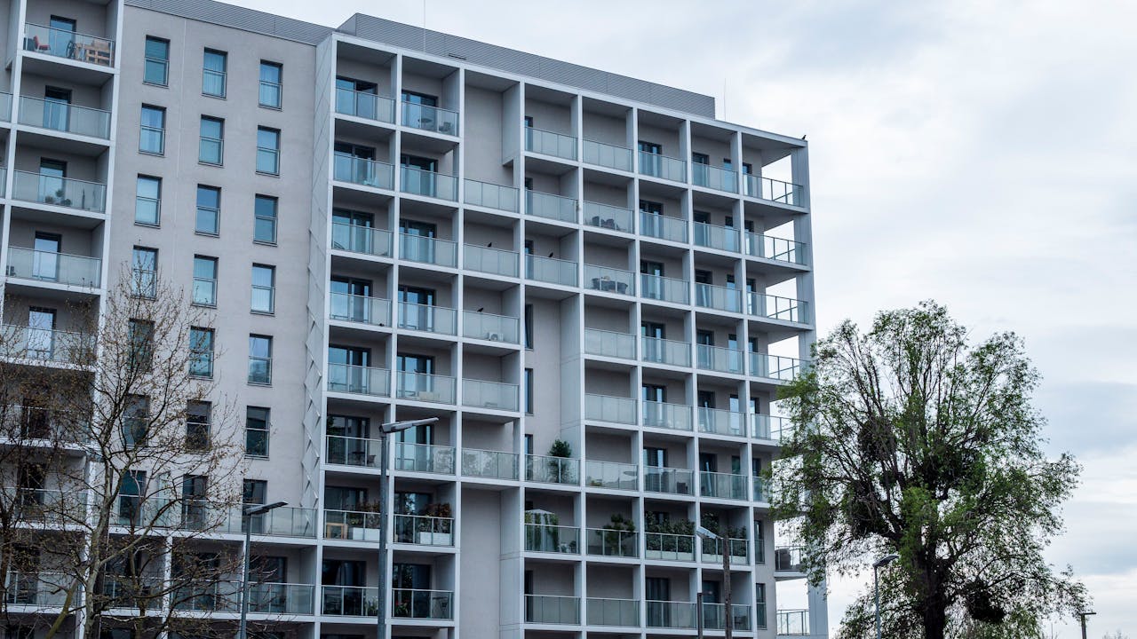 Edificio residencial mid-rise con balcones y ventanas amplias, imagen para post sobre departamentos en pozo en Caballito