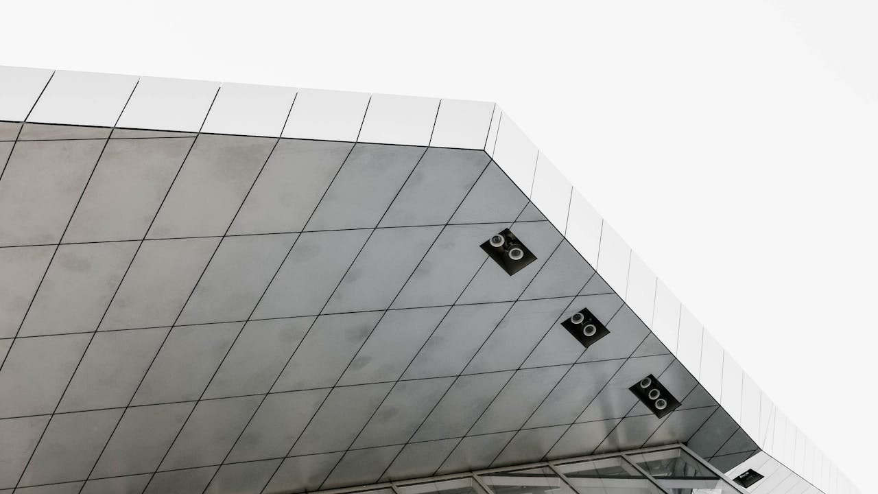 Edificio moderno con paneles de vidrio y fachada geometrica, imagen para guia que es un departamento en pozo